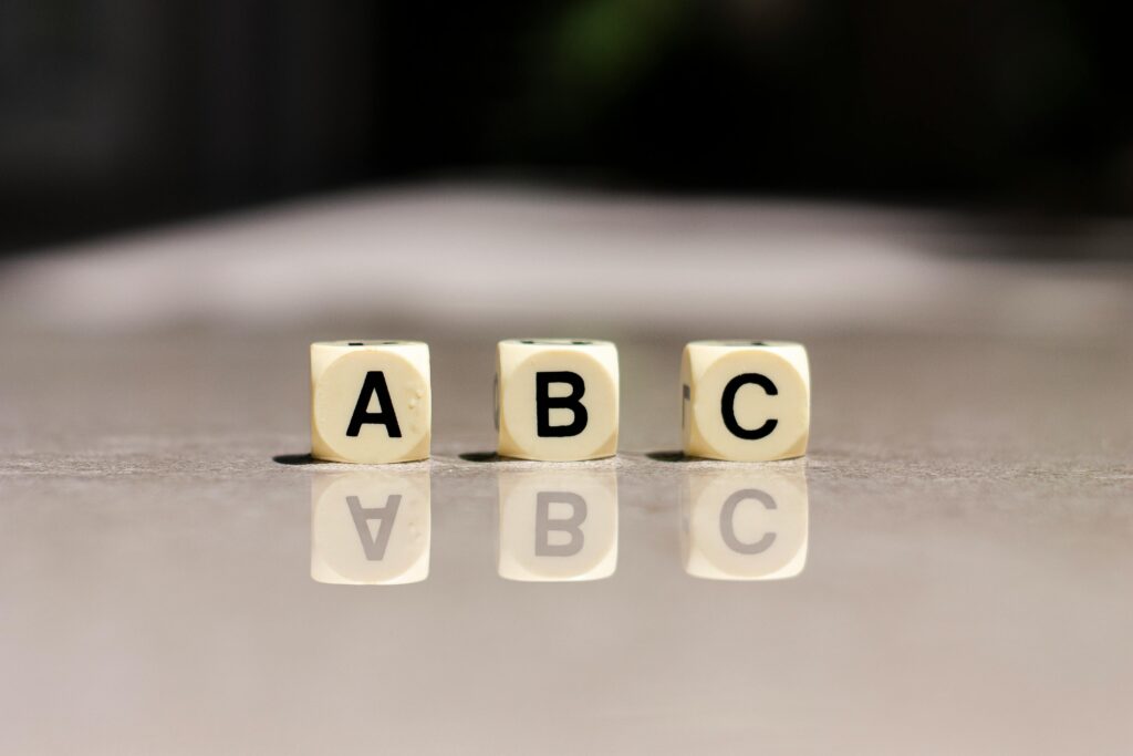 Close-up of alphabet dice showing A B C used in educational toddler games for early learning
