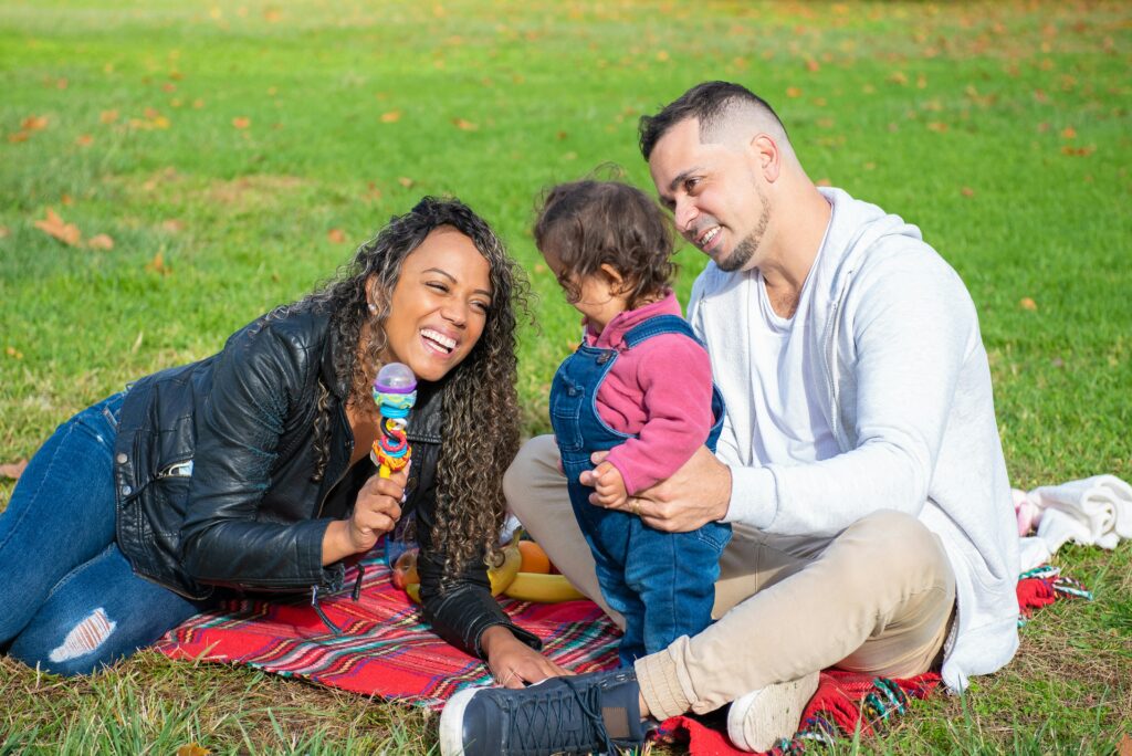 Family enjoying outdoor toddler activities and quality time together on a sunny day.