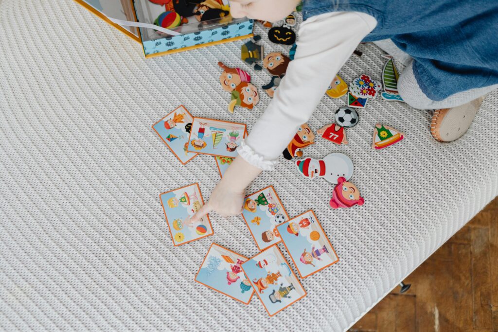 child has flash cards with different shapes to teach shapes to toddlers. 