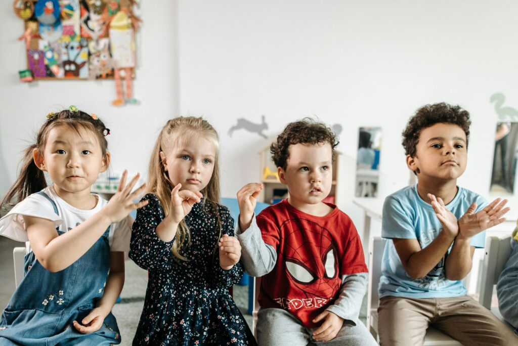 A group of diverse children engaged in a fun toddler activities in a preschool classroom setting.